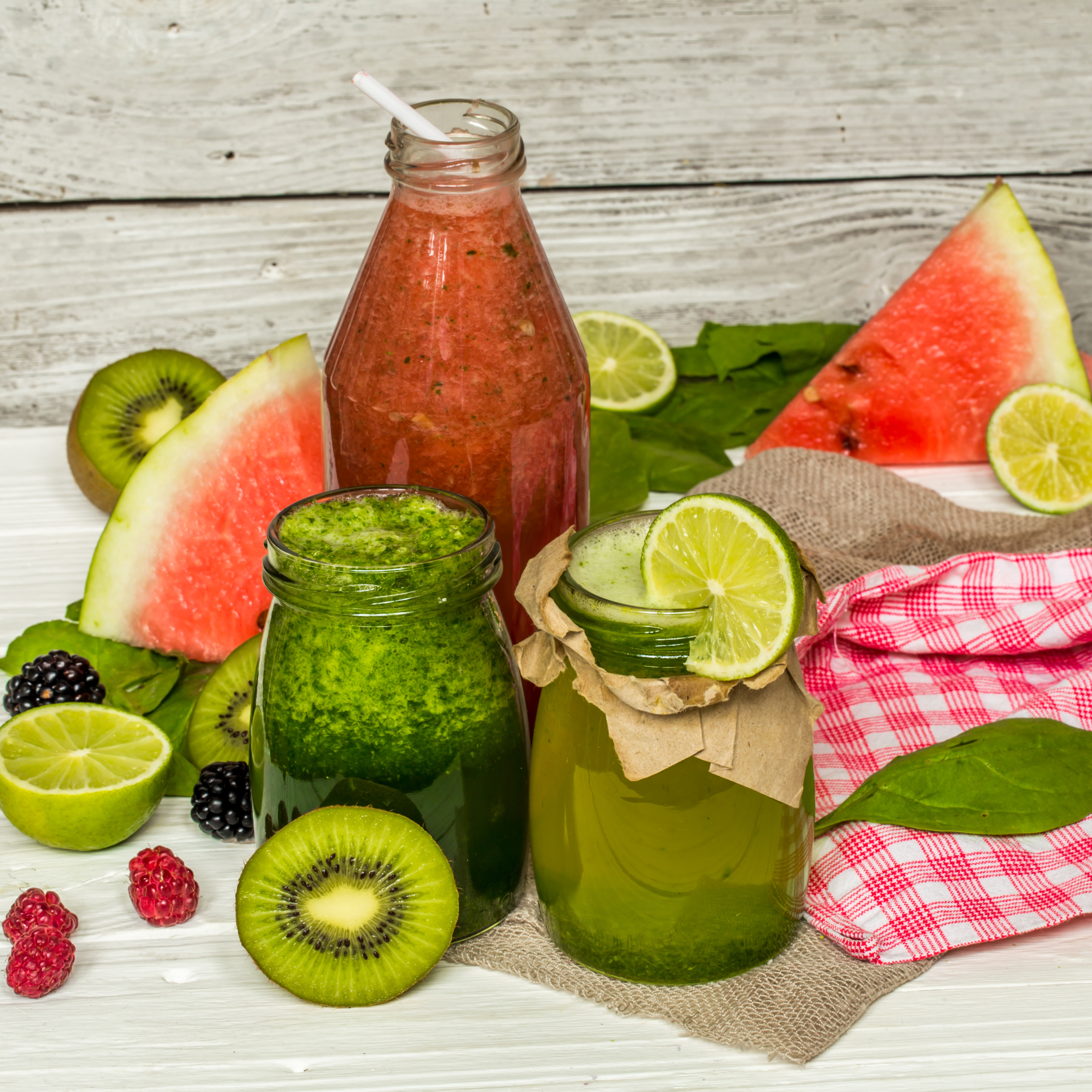 green and red smoothies in a jar with lime, kiwi